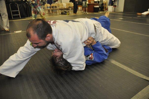 My instructor, mounted on me, in the longest minute of my BJJ life.